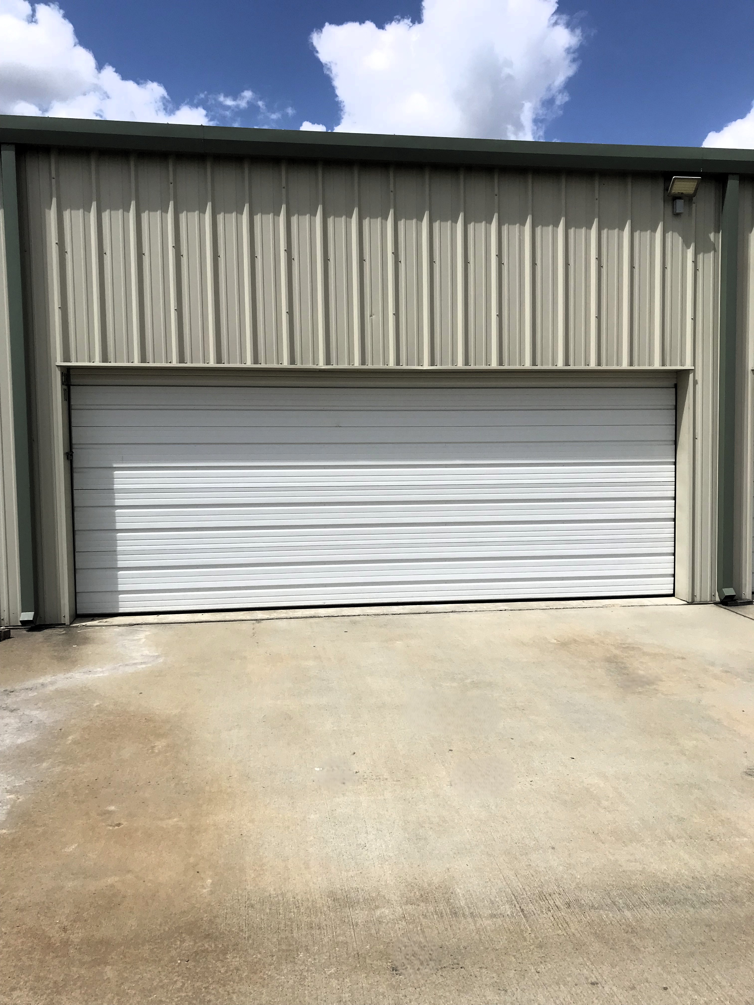 Vehicle Storage w/ Garage Style Roll Up Door - Wood RV & Self Storage